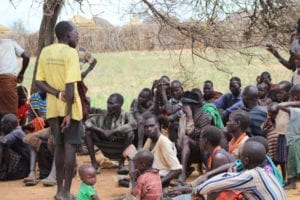 Ugandan people listening to a speaker