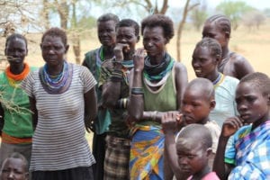 Ugandan women and children listening intently