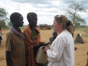 Woman missionary talking to Ugandan people