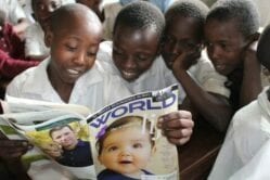 Ugandan kids reading a World magazine  